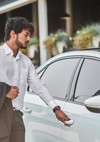 indian-businessman-opens-car-door_496169-2780