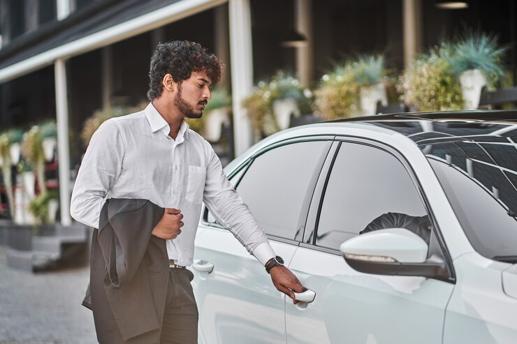indian-businessman-opens-car-door_496169-2780